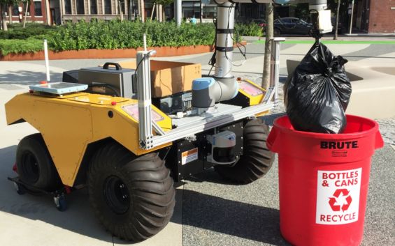 Autonomous mobile robot Husky picking up garbage bags